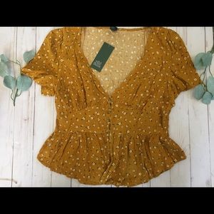 Mustard yellow blouse with white flowers